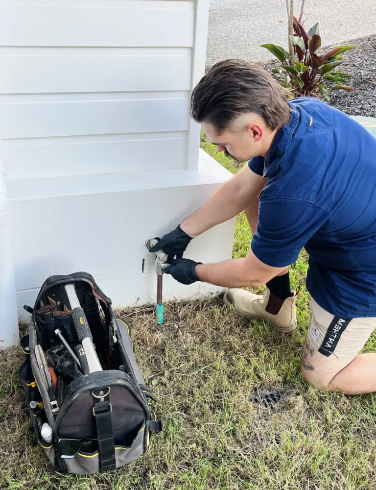 Qualified Plumber outside a home closing the main gas shut-off valve prior to maintenance. High Tide Plumbing on the Gold Coast