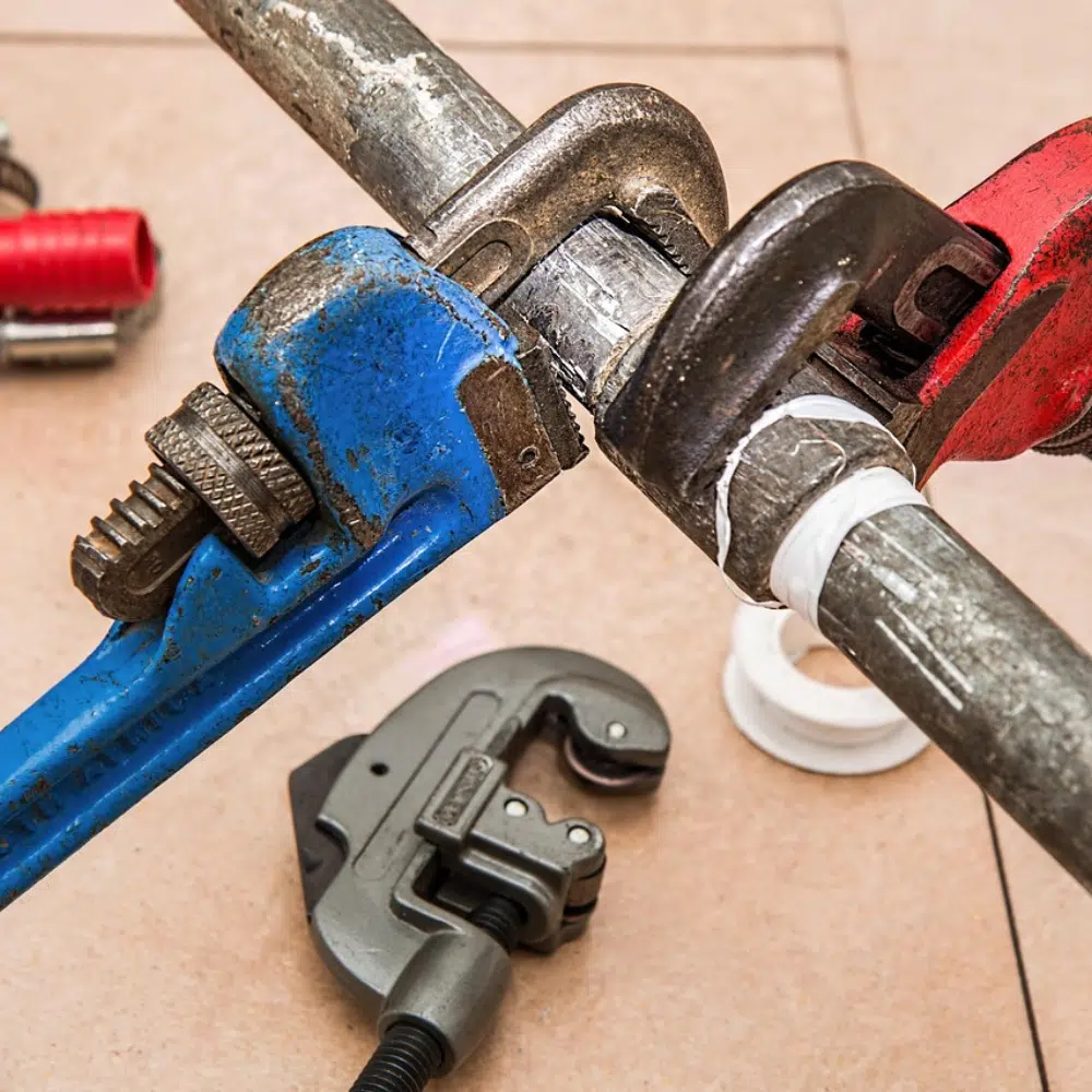 Two pairs of grips are used by a plumber for an Emergency Burst Pipe repair on the gold Coast