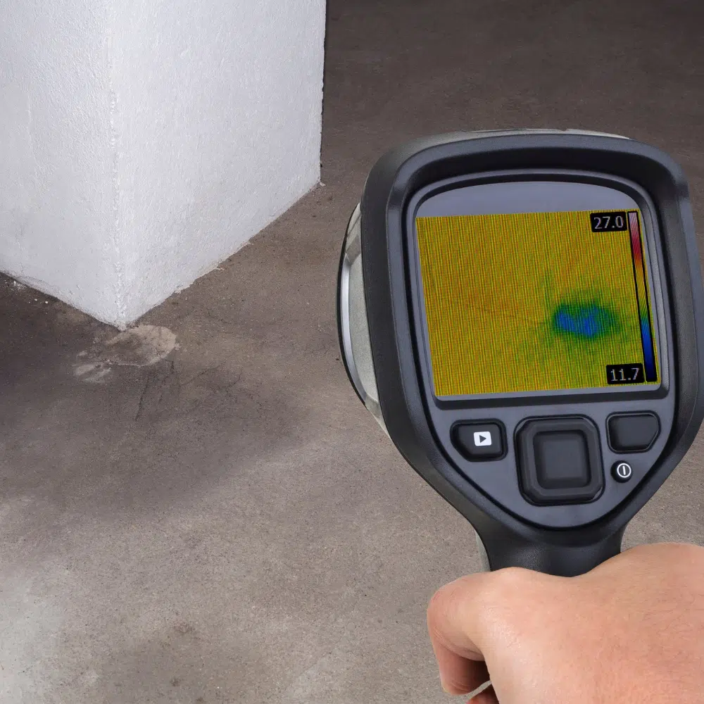 A Plumbing professional uses an electronic infrared device to search for moisture under floors and behind walls as Leak Detection On The Gold Coast